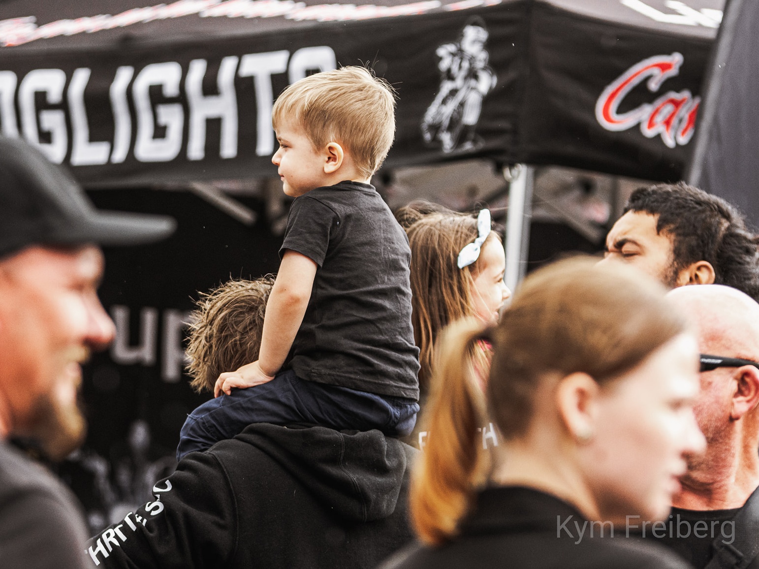 Kids sitting outside at motorbike show